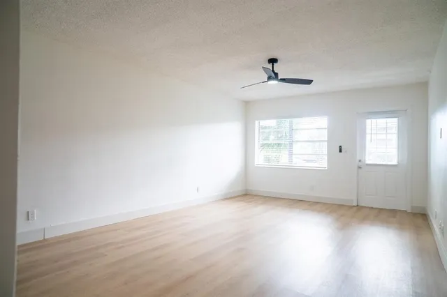a view of a kitchen with a sink hardwood floor and a ceiling fan