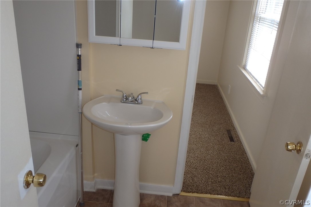 530 Riverview Road Colonial Heights, VA 23834 - Photo 4 of 10 a bathroom with a sink and mirror