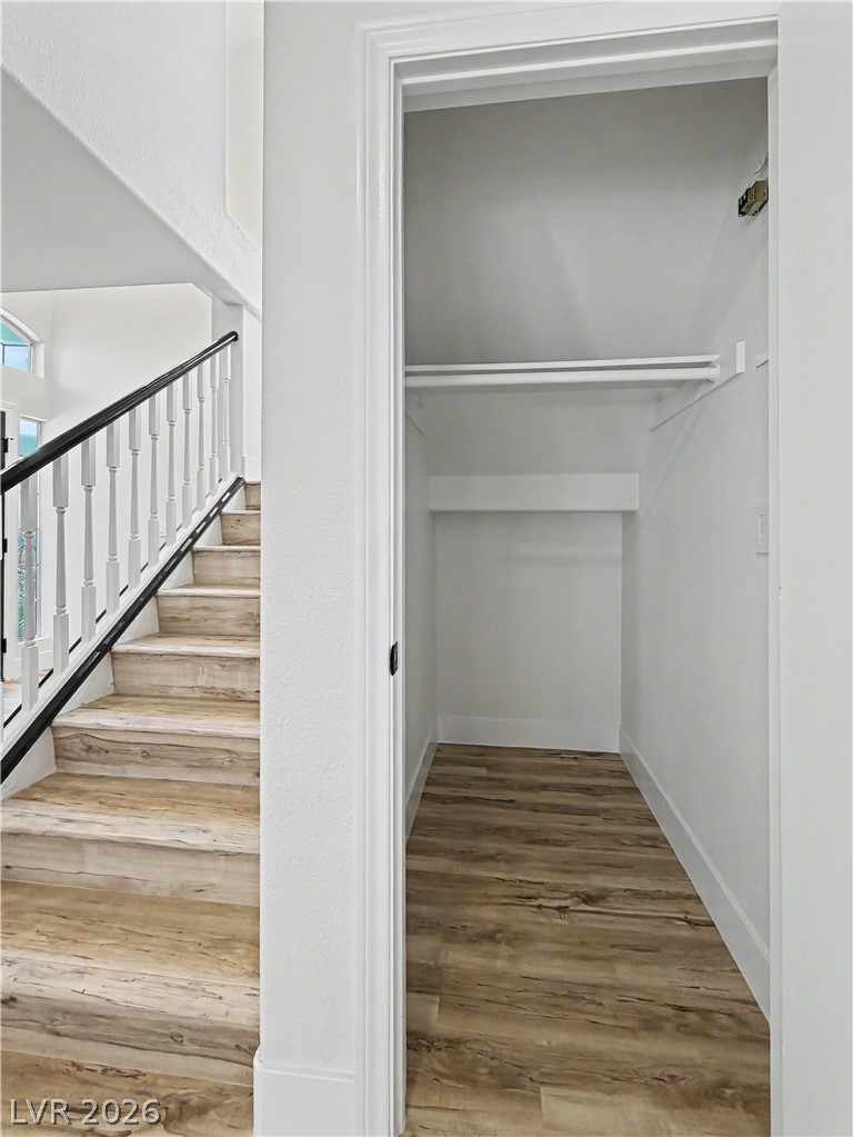 8977 Paige Rene Court Las Vegas, NV 89117 - Photo 28 of 31 A deep storage closet with modern wood-style flooring adjoins a staircase with contemporary railing.