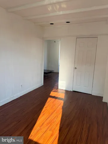 a view of an empty room and wooden floor