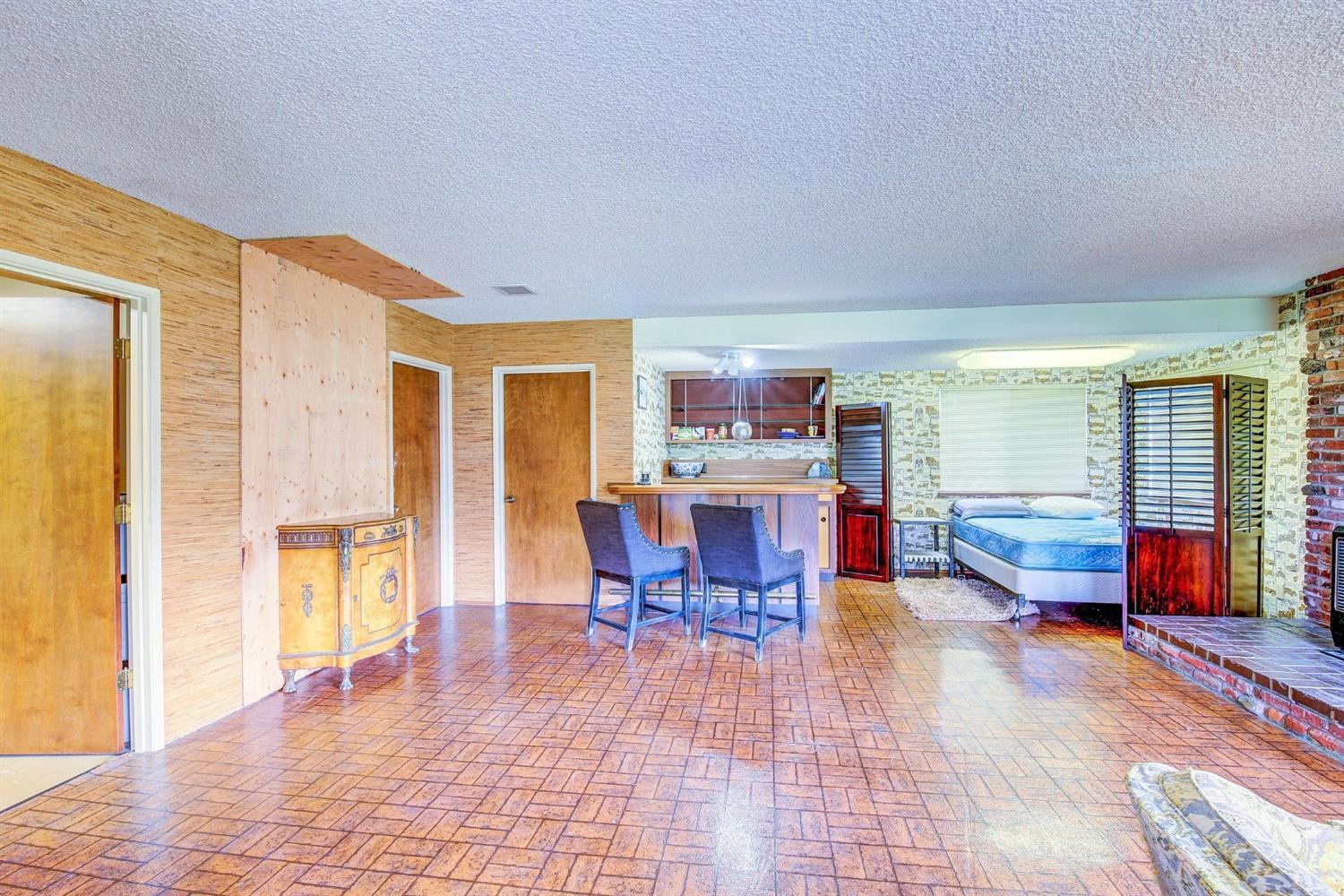 2655 Robertson Bridge Road Grants Pass, OR 97526 - Photo 21 of 31 a living room with furniture and a dining table with wooden floor