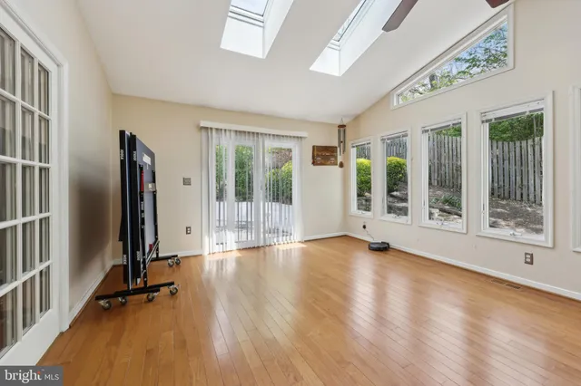 a view of room with wooden floor and floor to ceiling window