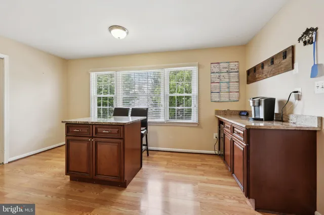 a kitchen with stainless steel appliances granite countertop a stove a sink dishwasher and a microwave oven with cabinets