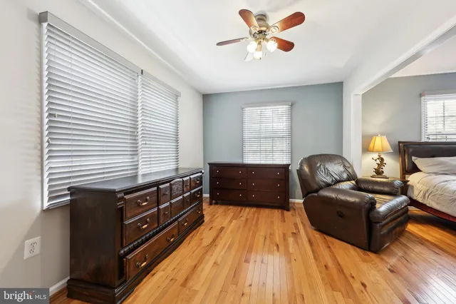 a bedroom with furniture and wooden floor