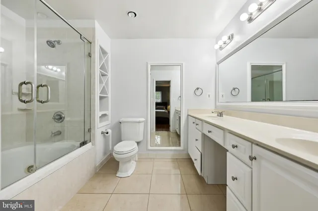 a spacious bathroom with a shower sink and mirror