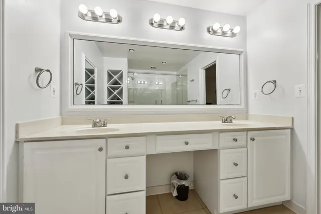 a bathroom with a double vanity sink and a mirror