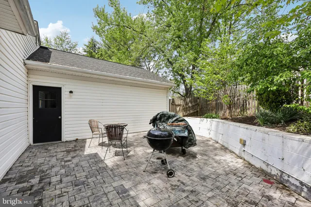 a white house that has a tree in front of it