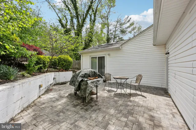 a view of backyard with seating and trees