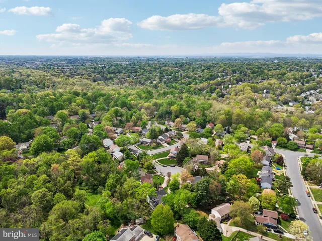 an aerial view of residential houses with city view