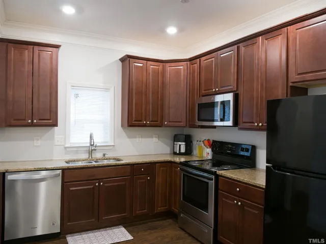 a kitchen with a sink a stove a microwave and refrigerator
