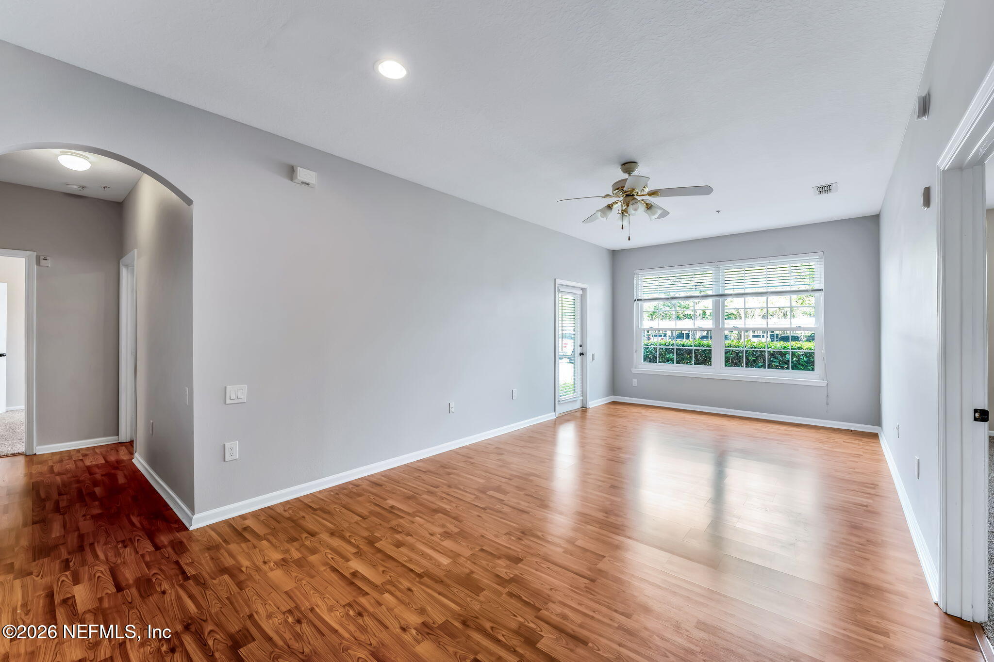 7990 Baymeadows Road East, Unit 520 Jacksonville, FL 32256 - Photo 11 of 41 wooden floor in an empty room with a window