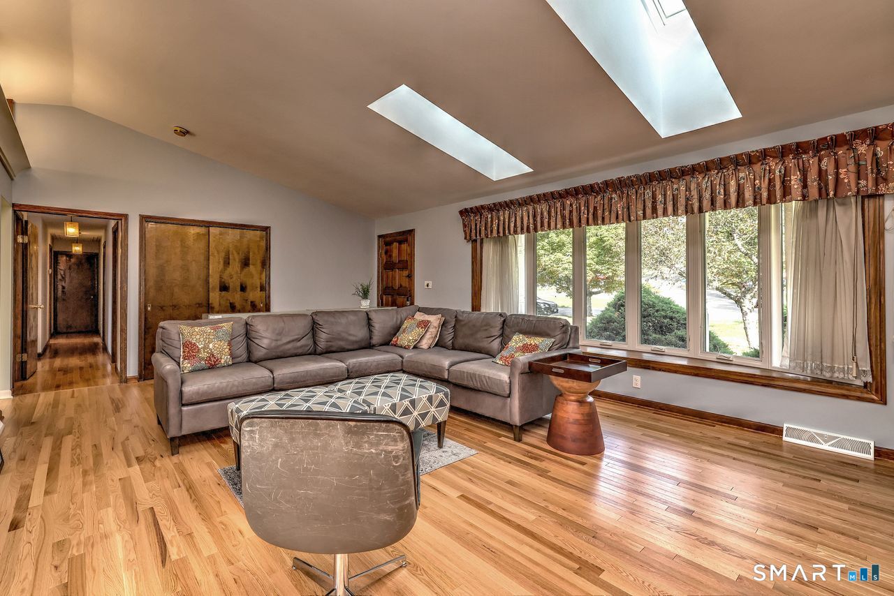 90 Brook Hill Road Hamden, CT 06514 - Photo 12 of 38 Living room with fire place, hardwood floor and skylight