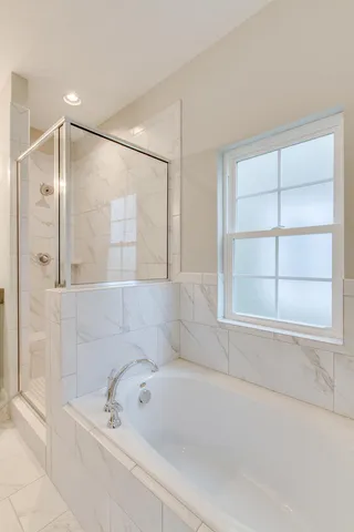 a bathroom with a bathtub and a shower