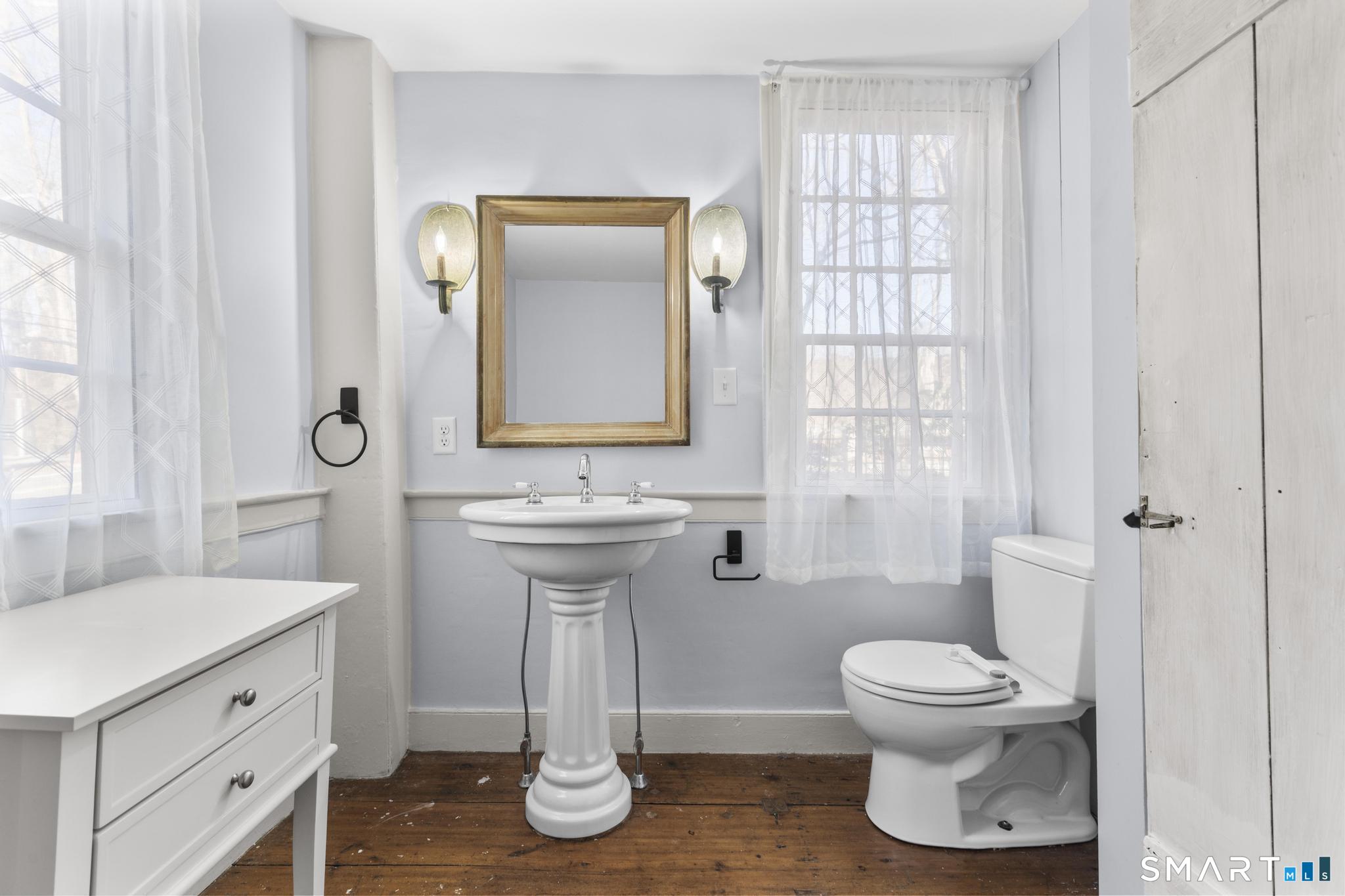 1 Ferry Road Chester, CT 06412 - Photo 12 of 40 a bathroom with a toilet sink and mirror