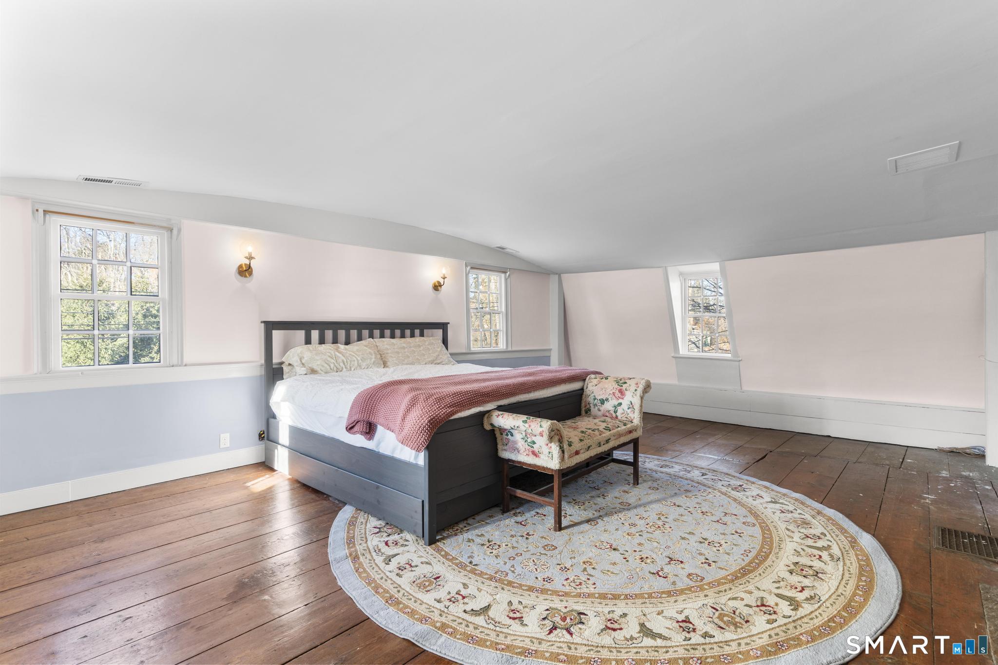 1 Ferry Road Chester, CT 06412 - Photo 16 of 40 a bedroom with a bed and wooden floor