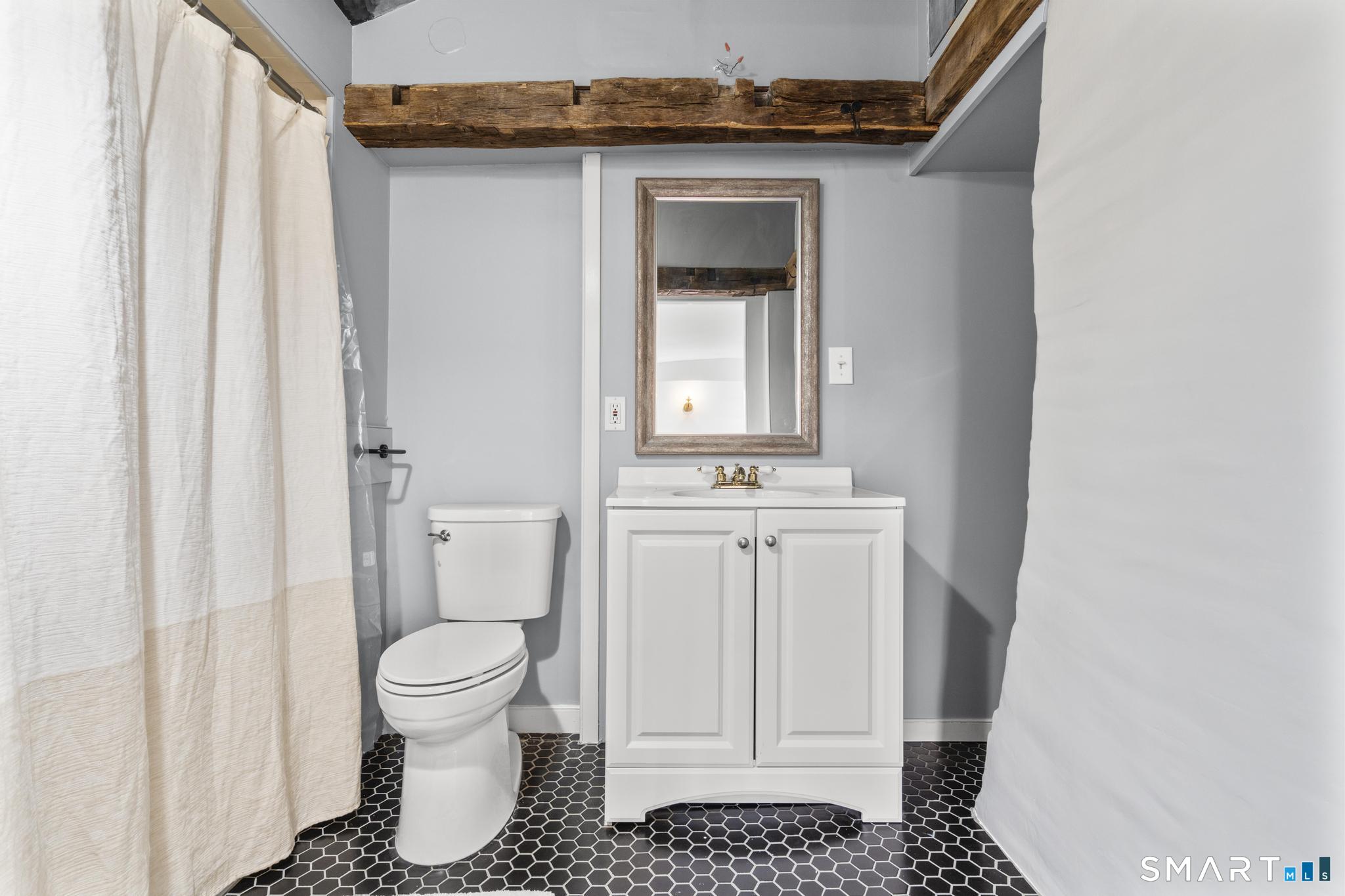 1 Ferry Road Chester, CT 06412 - Photo 18 of 40 a bathroom with a sink toilet and window