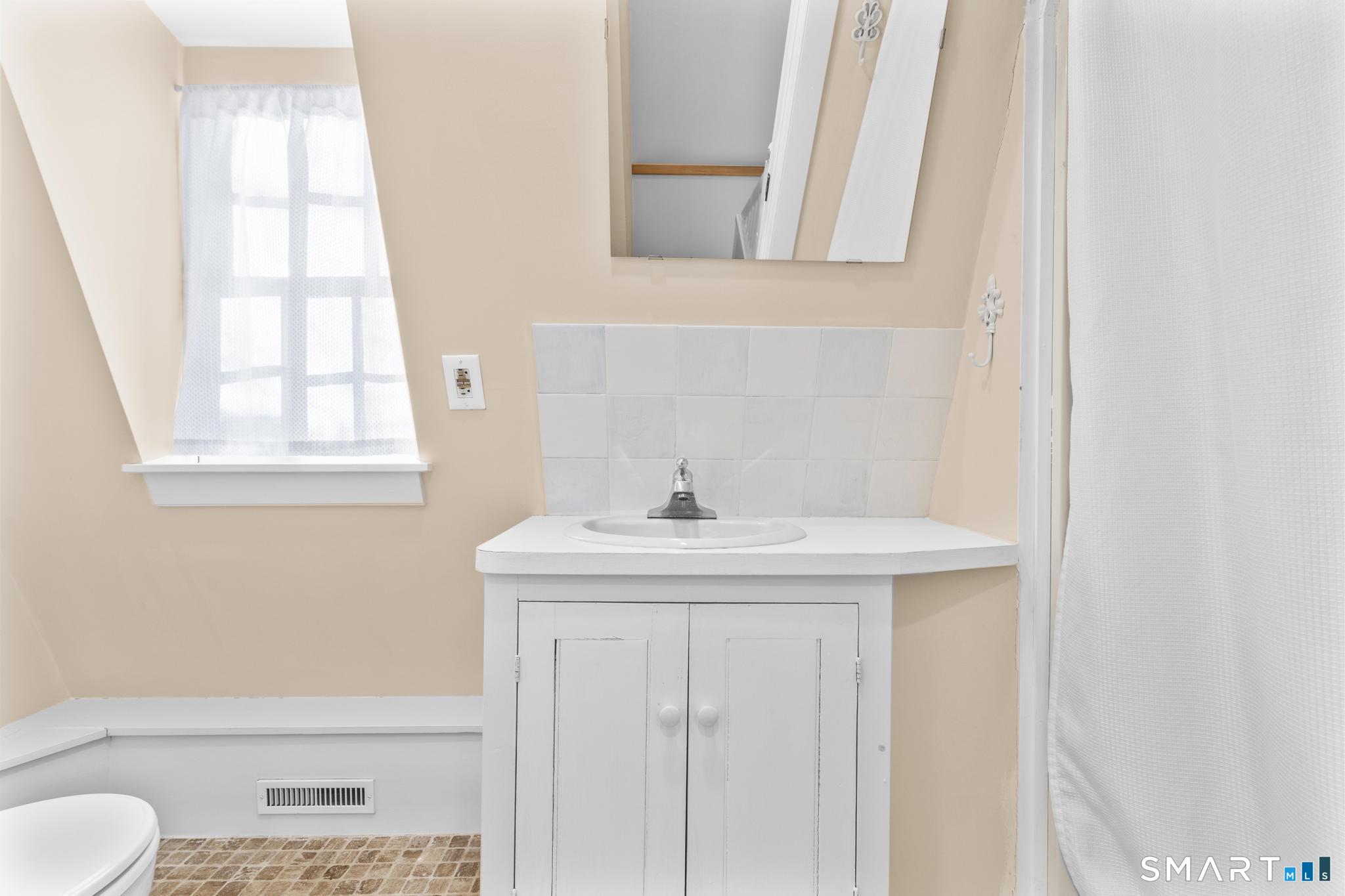 1 Ferry Road Chester, CT 06412 - Photo 26 of 40 a bathroom with a sink a toilet and a window