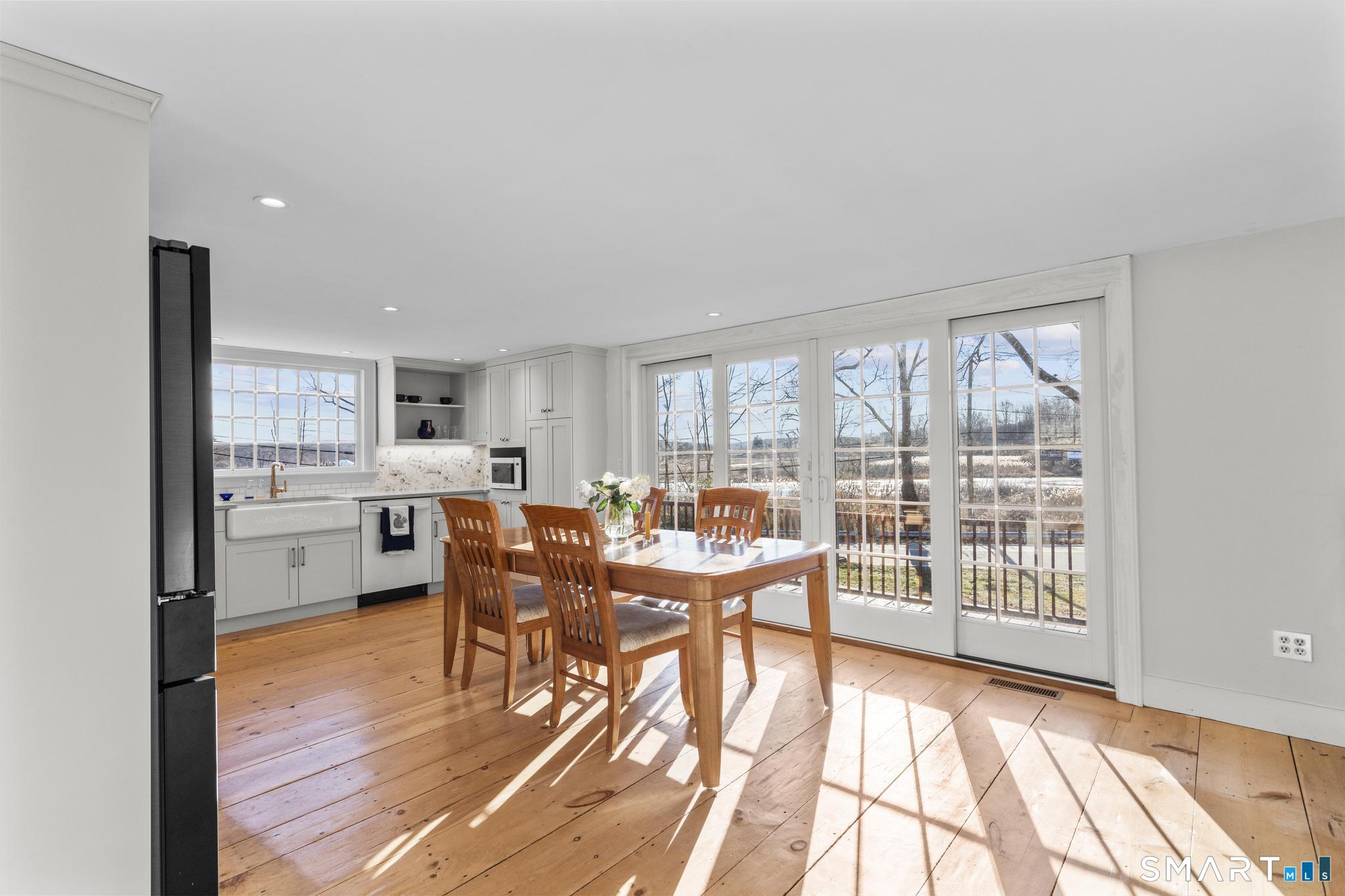 1 Ferry Road Chester, CT 06412 - Photo 5 of 40 a view of a dining room with furniture a chandelier and wooden floor