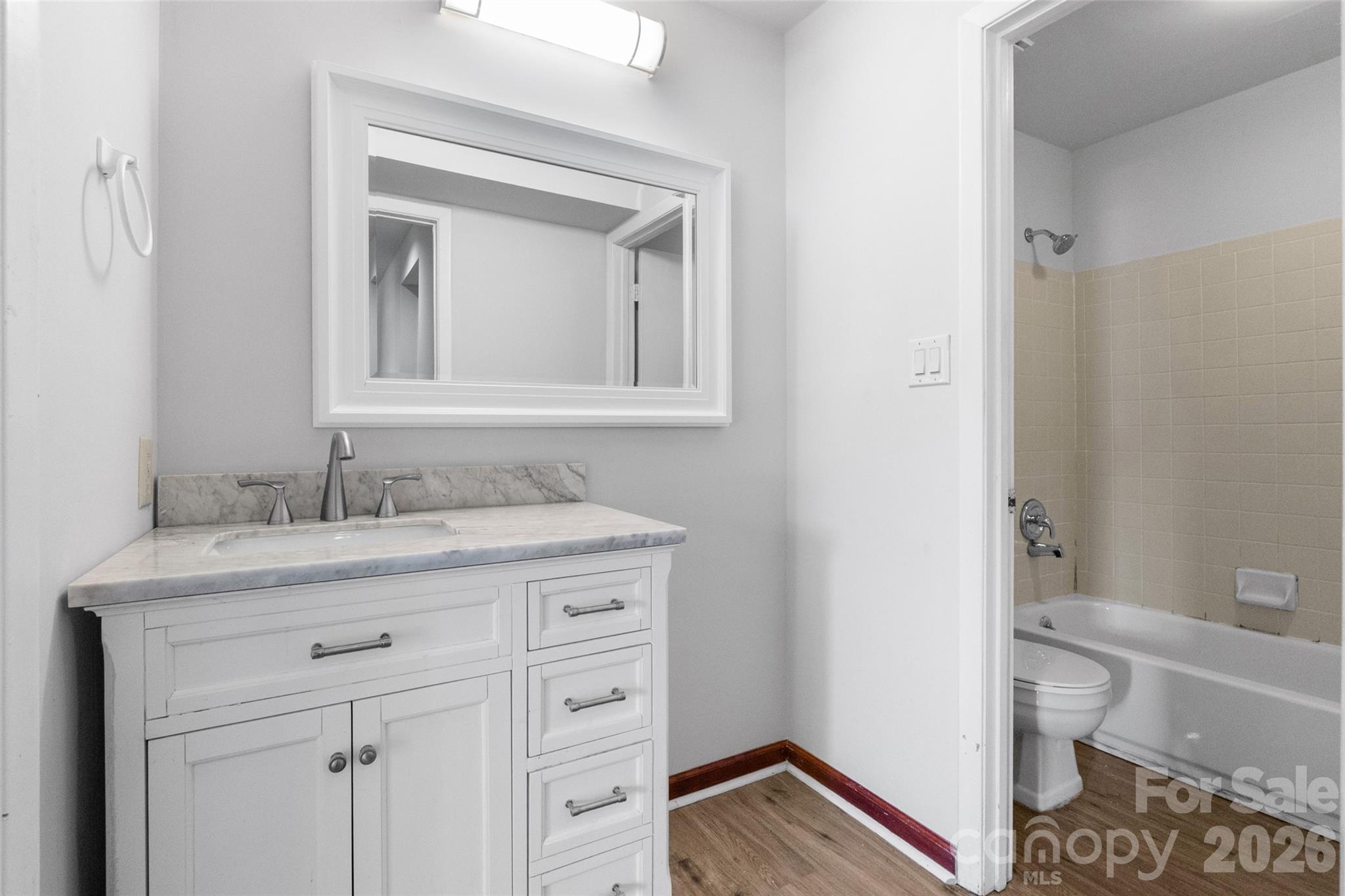5016 Sardis Road, Unit C Charlotte, NC 28270 - Photo 13 of 25 a bathroom with a granite countertop sink a toilet and a mirror