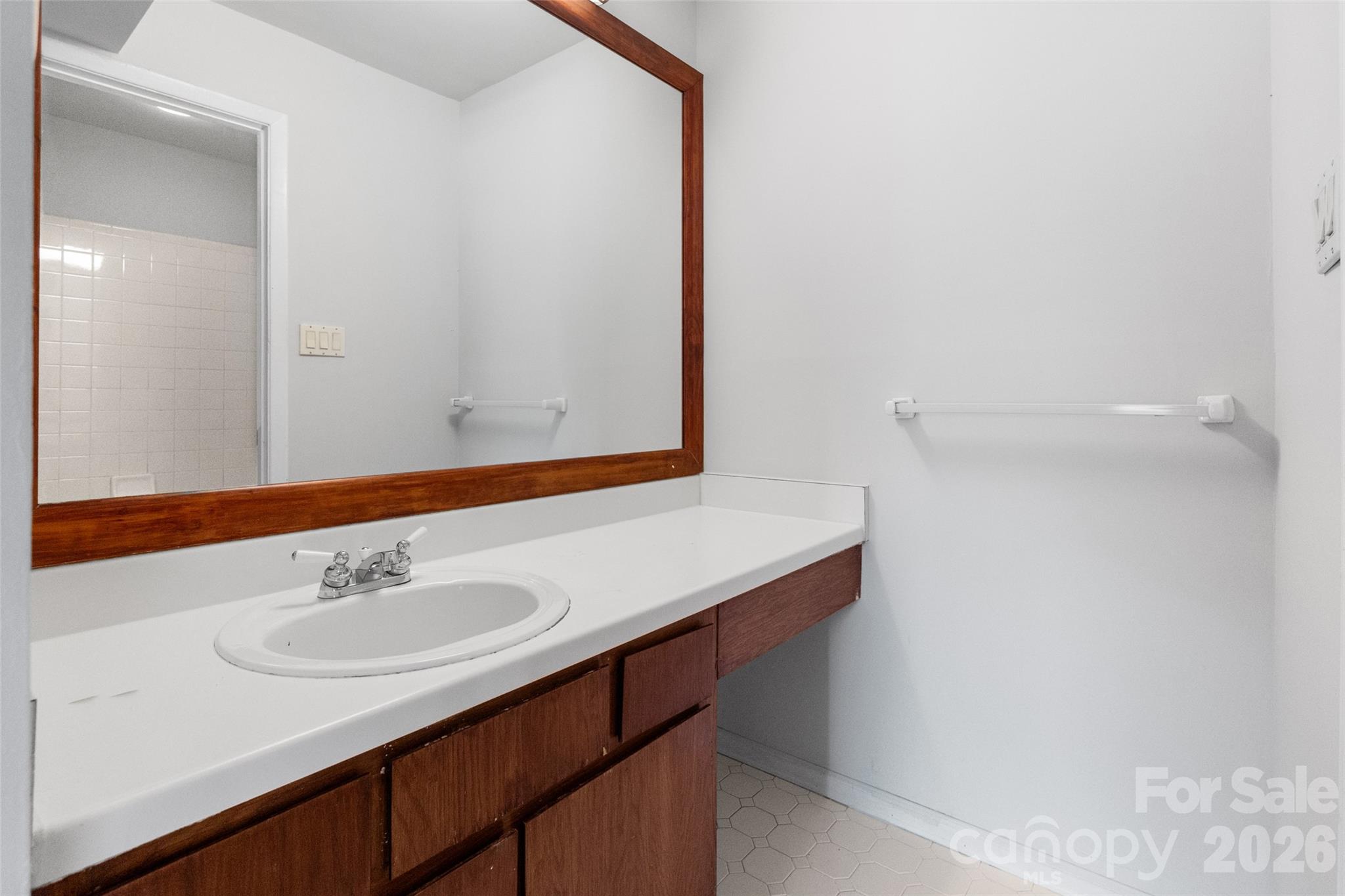 5016 Sardis Road, Unit C Charlotte, NC 28270 - Photo 17 of 25 a bathroom with a sink and a mirror