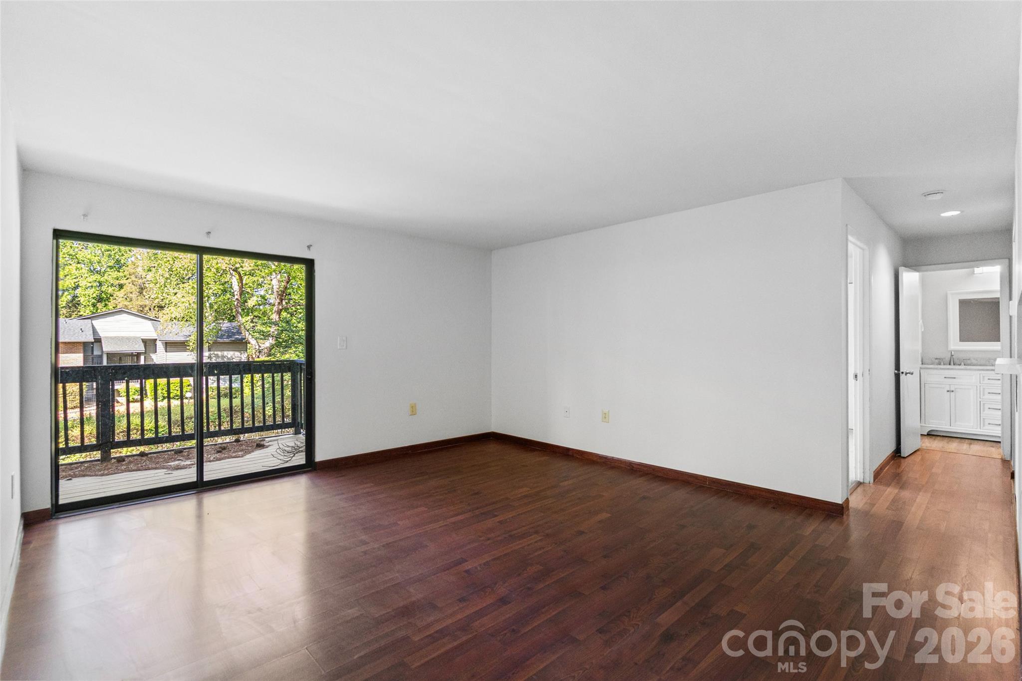 5016 Sardis Road, Unit C Charlotte, NC 28270 - Photo 3 of 25 an empty room with wooden floor and windows