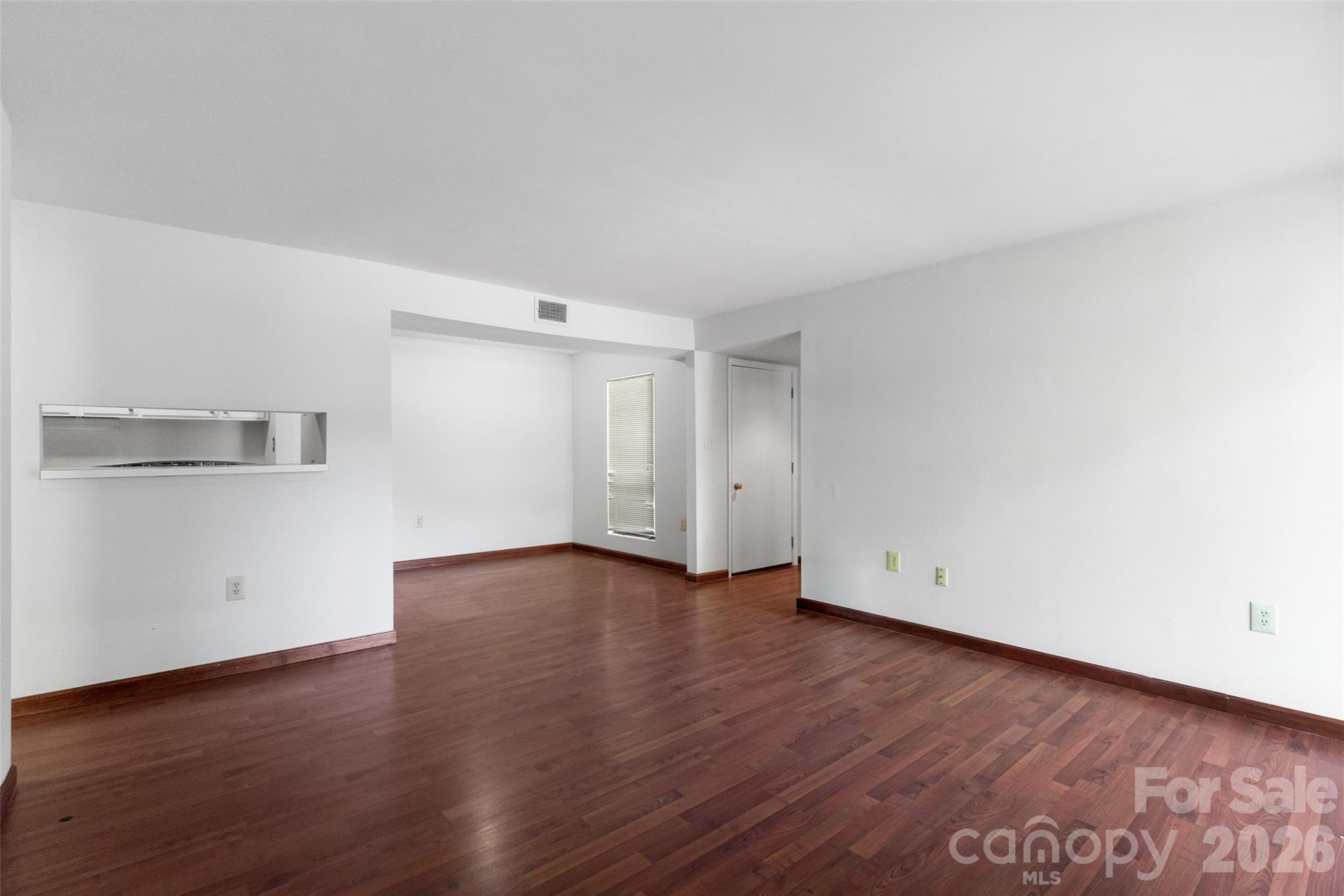 5016 Sardis Road, Unit C Charlotte, NC 28270 - Photo 5 of 25 a view of an empty room with wooden floor and closet