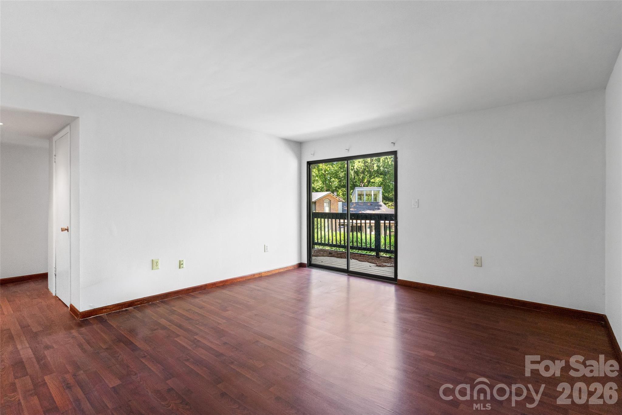 5016 Sardis Road, Unit C Charlotte, NC 28270 - Photo 6 of 25 an empty room with wooden floor and windows