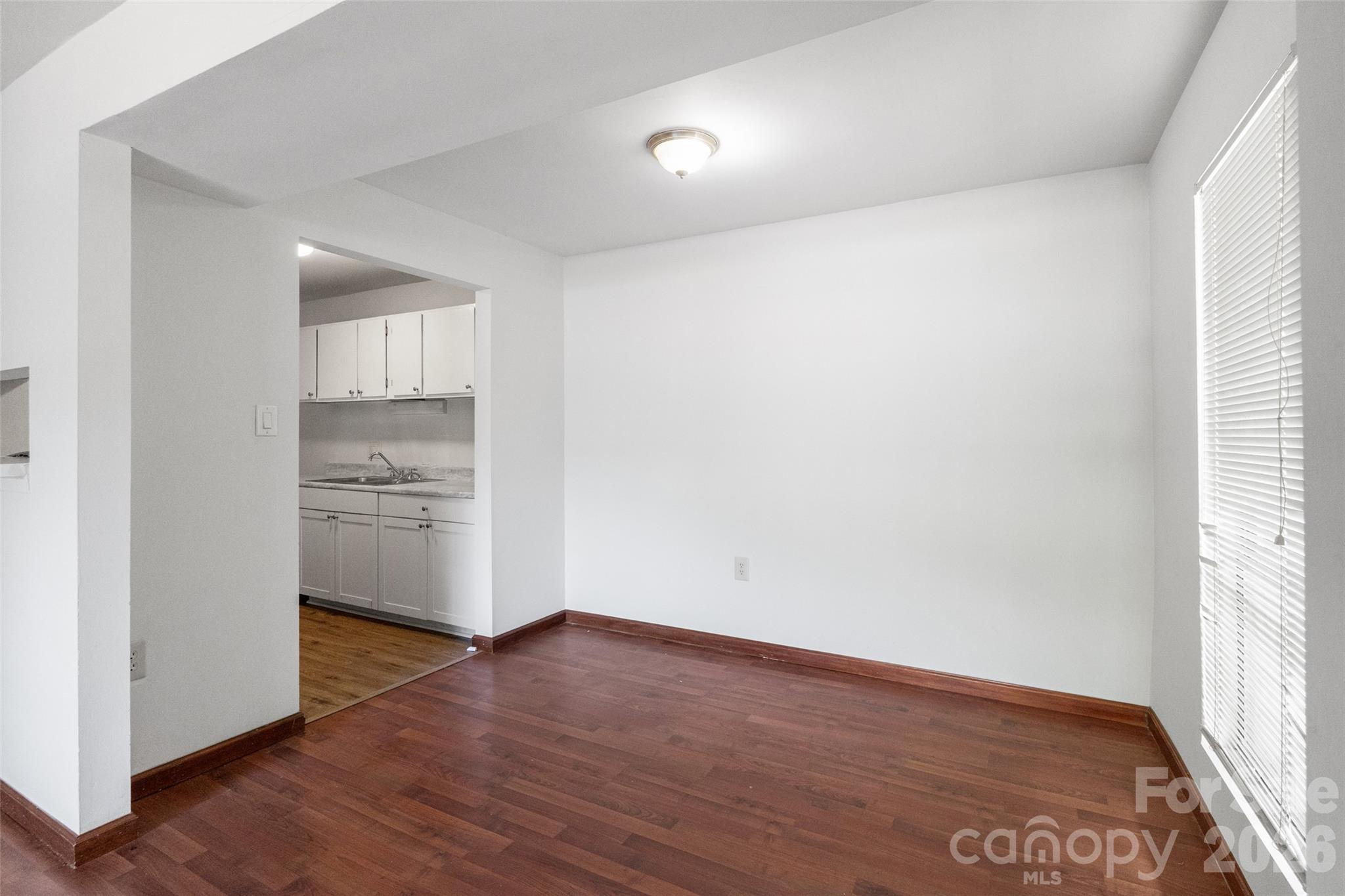 5016 Sardis Road, Unit C Charlotte, NC 28270 - Photo 7 of 25 a view of a kitchen with wooden floor and a sink