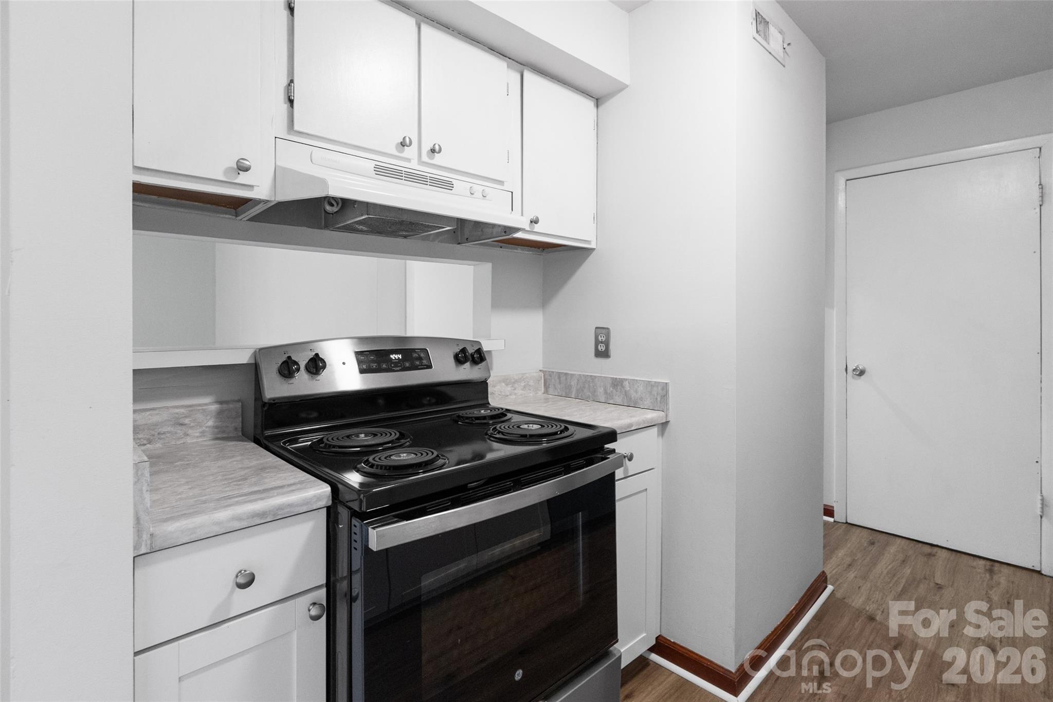 5016 Sardis Road, Unit C Charlotte, NC 28270 - Photo 9 of 25 a kitchen with granite countertop white cabinets and appliances