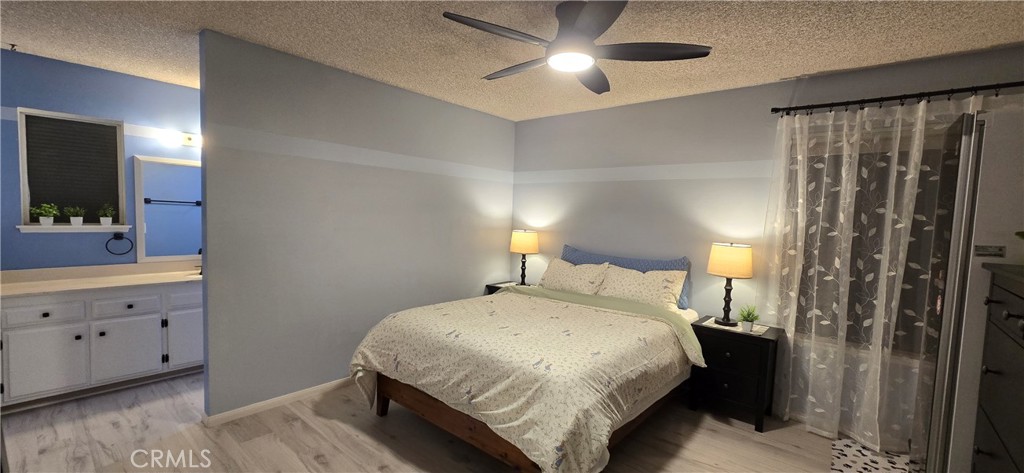 6830 Astoria Drive Riverside, CA 92503 - Photo 19 of 23 a bedroom with a bed and a mirror on dresser
