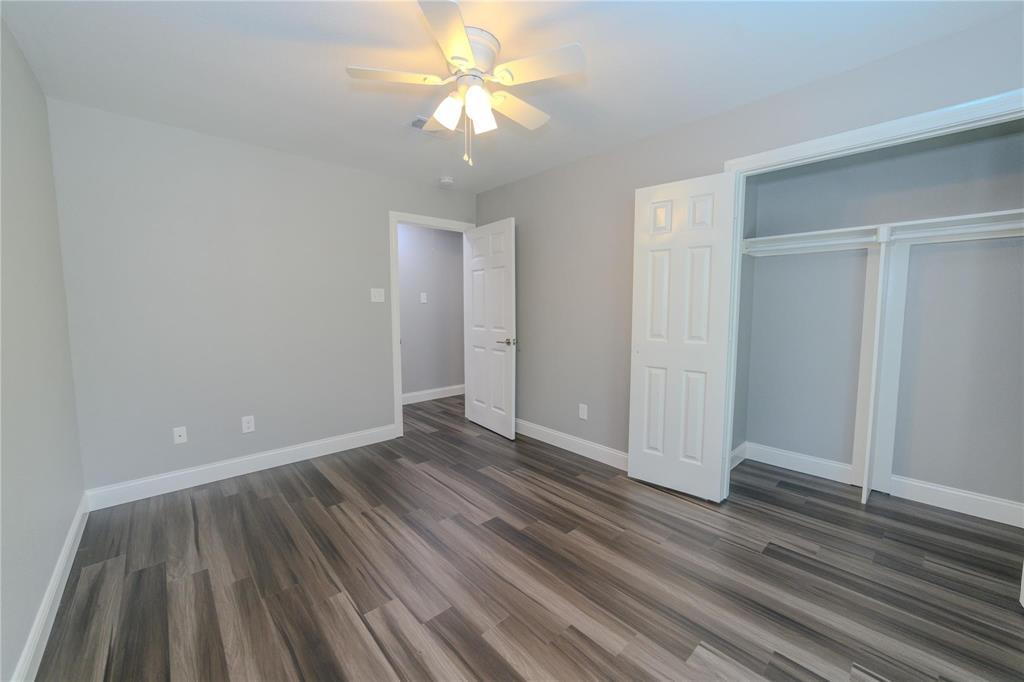 809 Wilcox Street McKinney, TX 75069 - Photo 16 of 26 Unfurnished bedroom with a ceiling fan, dark wood-type flooring, and a closet