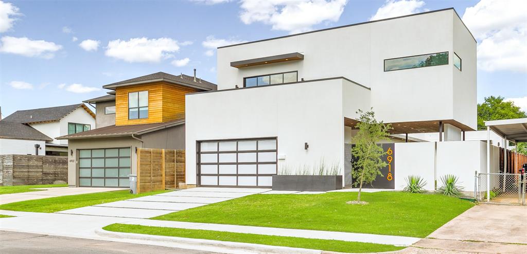 a view of a house with a backyard and a garage