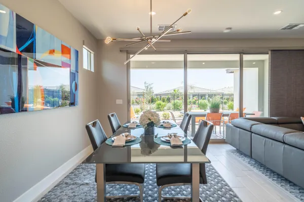a dining room with furniture a rug and a large window