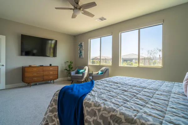 a bedroom with furniture and a flat screen tv