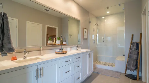 a bathroom with a double vanity sink and a mirror