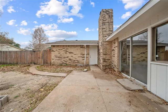 a view of a porch with couches and wooden fence