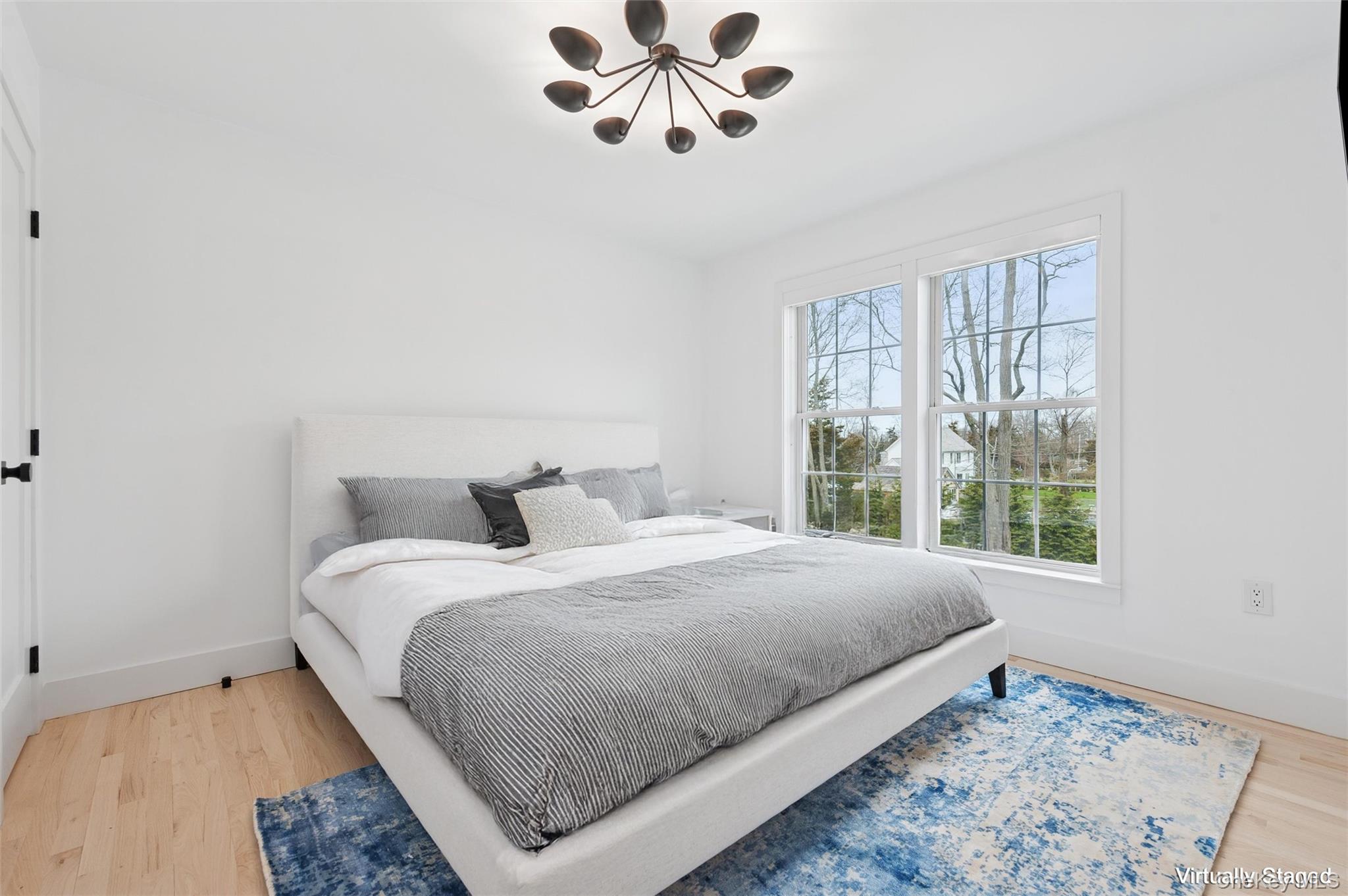 4056 Noyack Road Sag Harbor, NY 11963 - Photo 13 of 21 a bedroom with a bed and a window