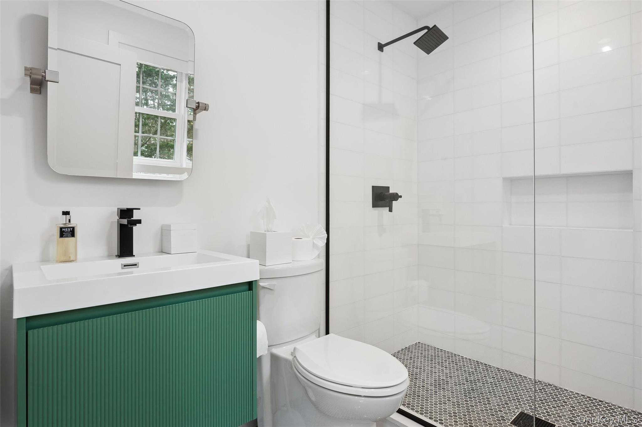 4056 Noyack Road Sag Harbor, NY 11963 - Photo 15 of 21 a bathroom with a sink a toilet and shower