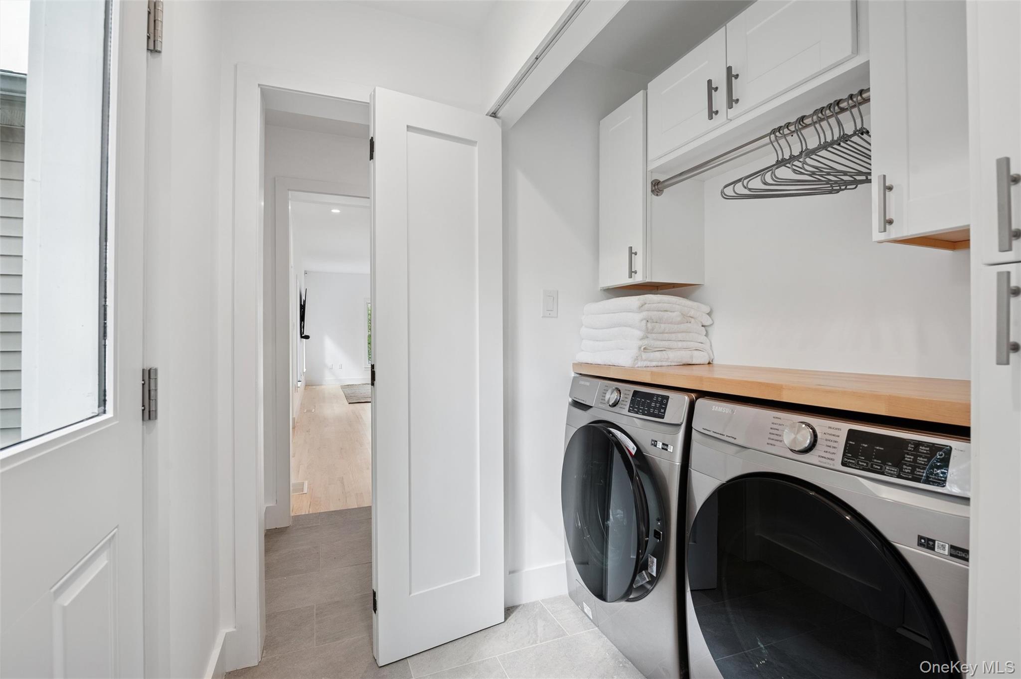 4056 Noyack Road Sag Harbor, NY 11963 - Photo 18 of 21 a utility room with dryer and washer