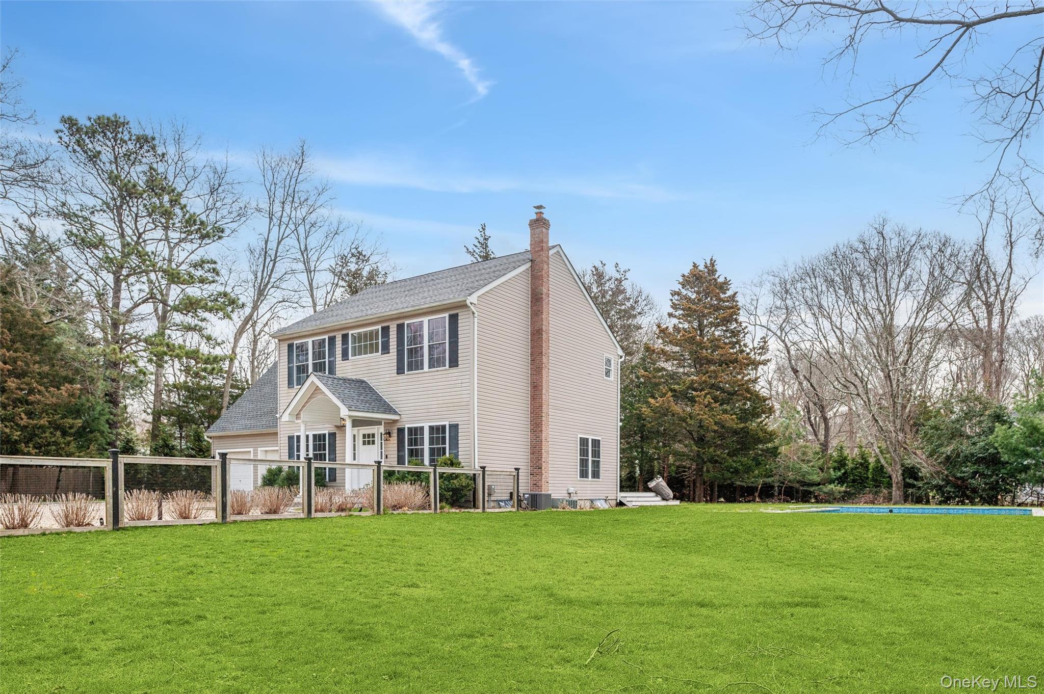 4056 Noyack Road Sag Harbor, NY 11963 - Photo 20 of 21 a view of a house with a yard
