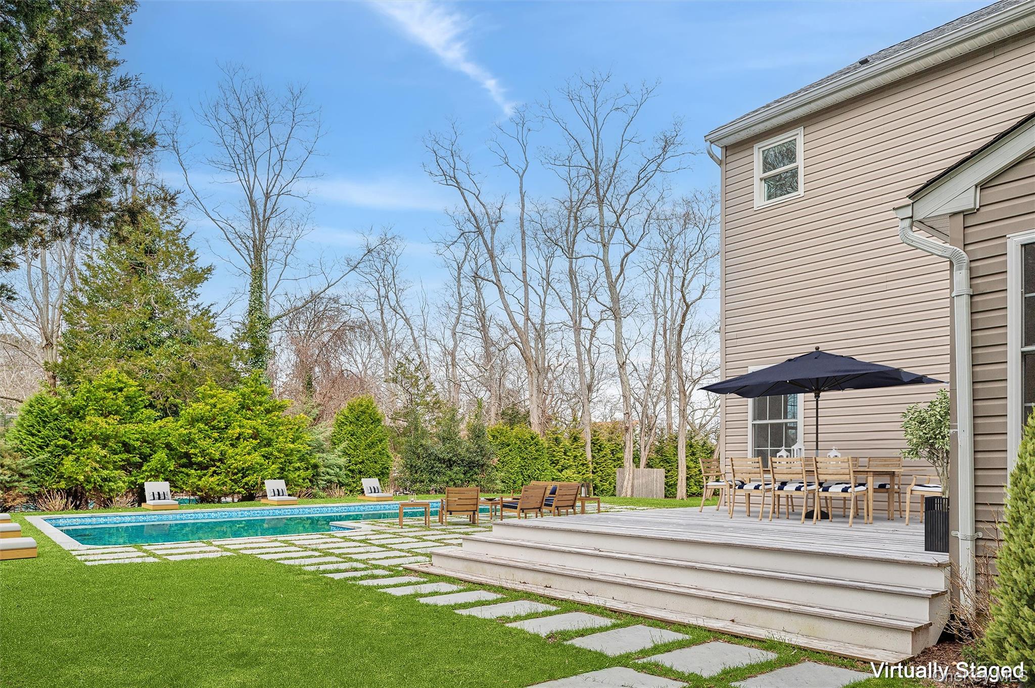 4056 Noyack Road Sag Harbor, NY 11963 - Photo 2 of 21 a front view of a house with a yard