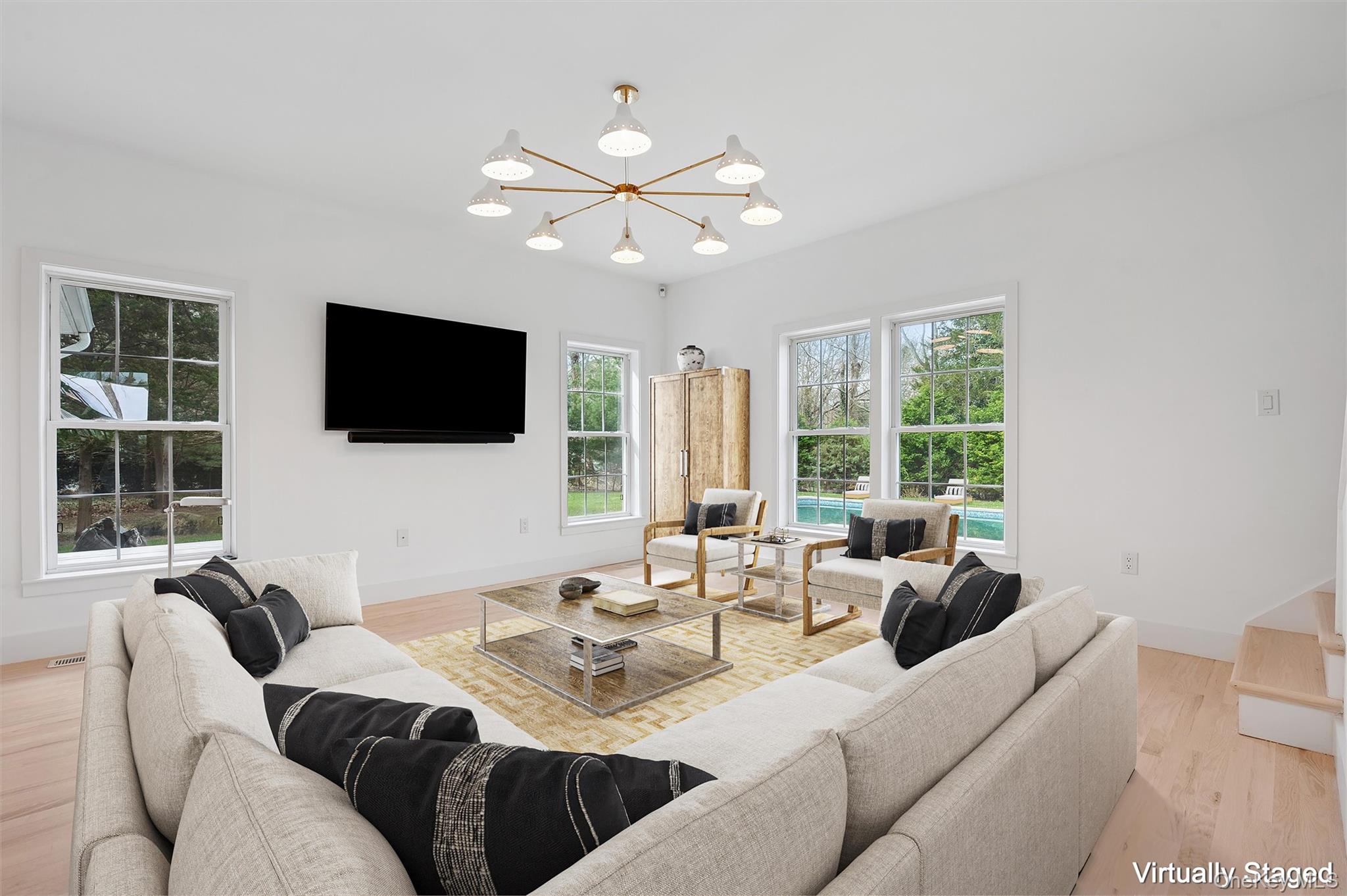 4056 Noyack Road Sag Harbor, NY 11963 - Photo 5 of 21 a living room with furniture a flat screen tv and a large window