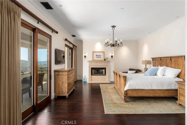 a bedroom with a large bed and a flat tv screen