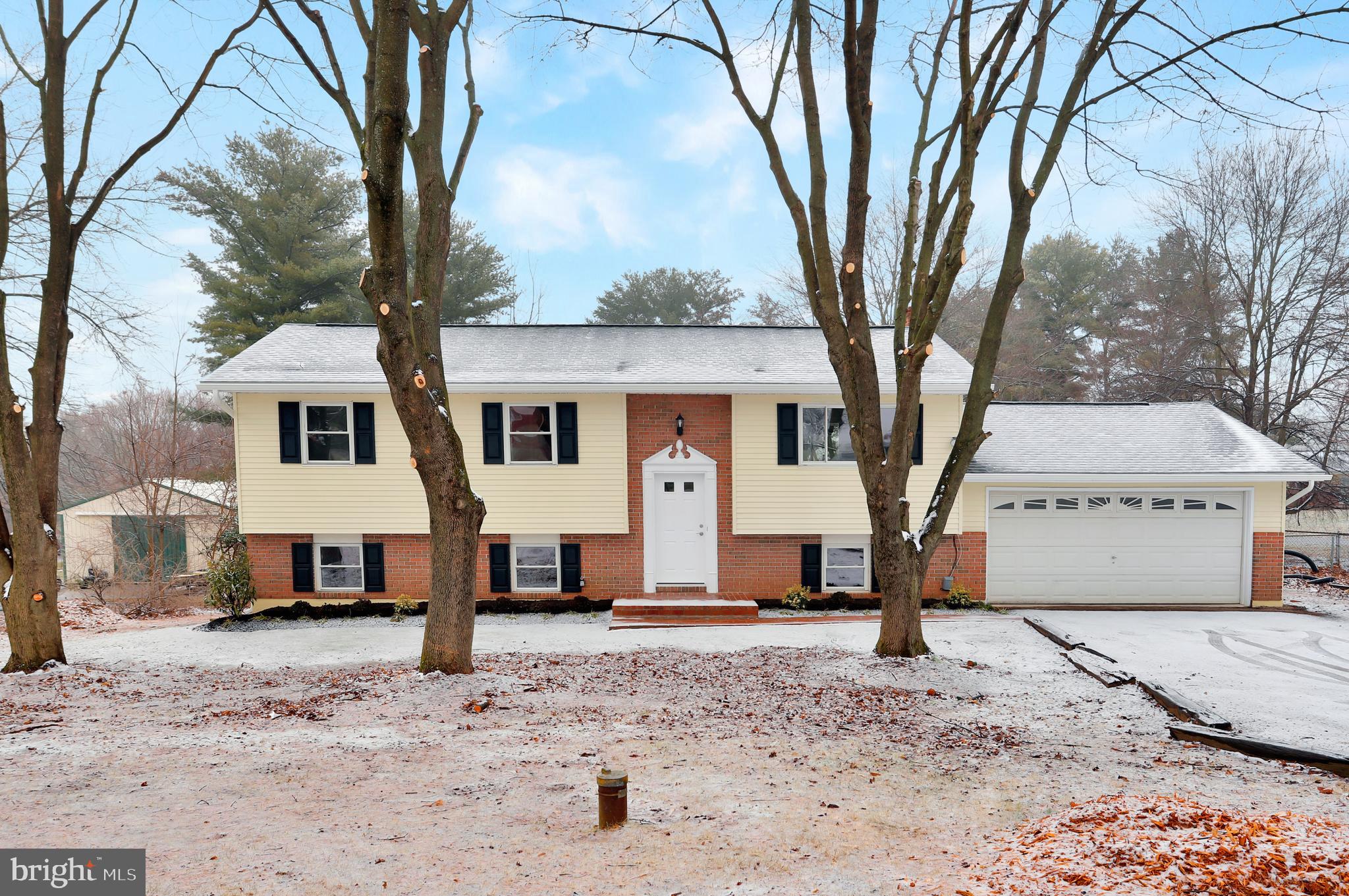 4355 Ridge Road Mount Airy, MD 21771 - Photo 1 of 54 a front view of a house with a yard covered with snow and trees