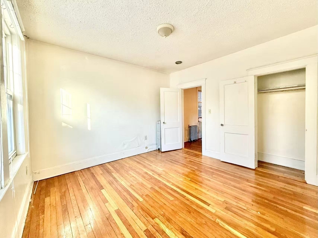 26 Chiswick Road, Unit 6 Boston, MA 02135 - Photo 13 of 19 a view of an empty room with wooden floor and a window