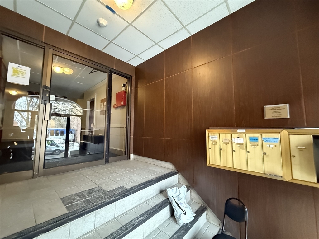 26 Chiswick Road, Unit 6 Boston, MA 02135 - Photo 18 of 19 a spacious bathroom with a granite countertop sink and a mirror