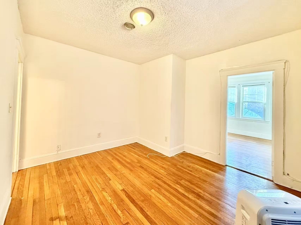 26 Chiswick Road, Unit 6 Boston, MA 02135 - Photo 9 of 19 a view of empty room with wooden floor