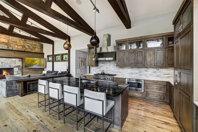 a living room with furniture a fireplace and a floor to ceiling window