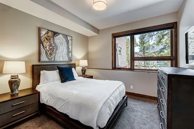 a bedroom with a large bed and a window