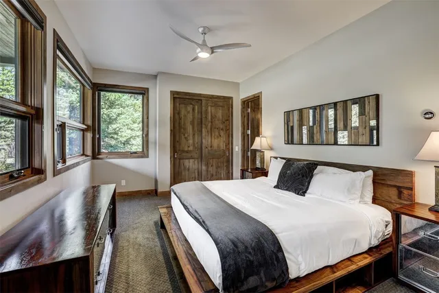 a bedroom with a bed and a large window